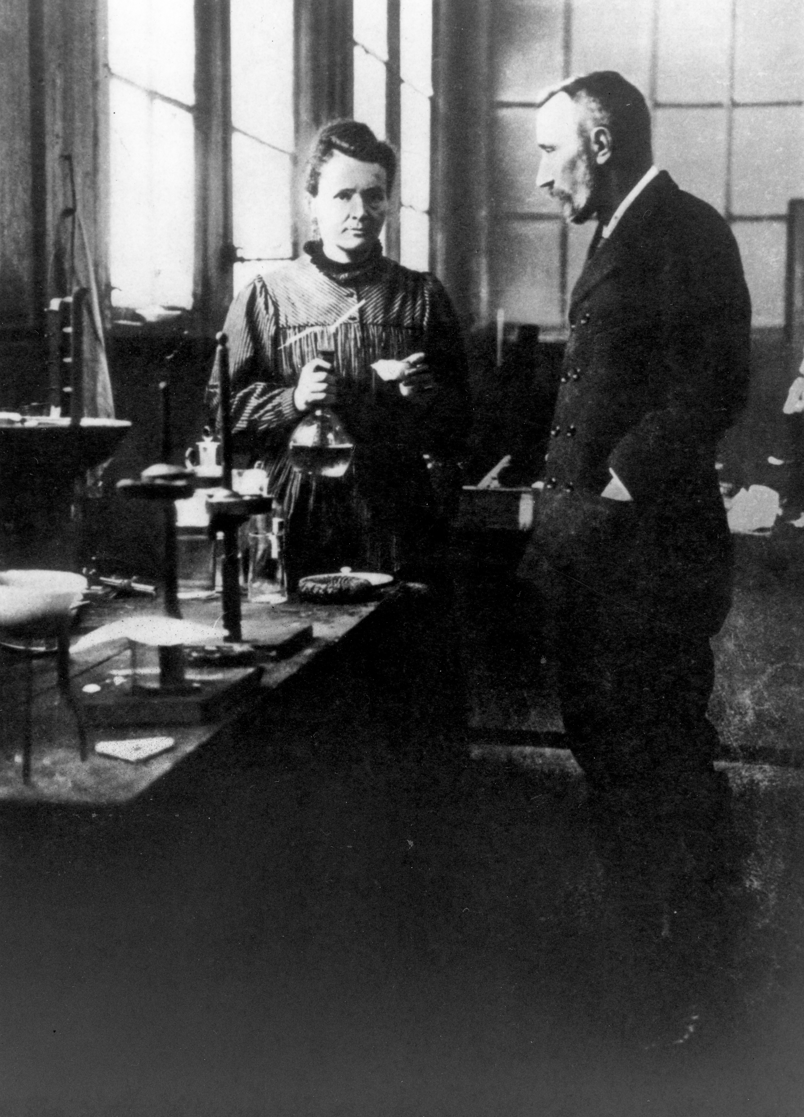 Мария и Пьер Кюри беседуют в лаборатории; архив AIP, фотография 1896 года.
